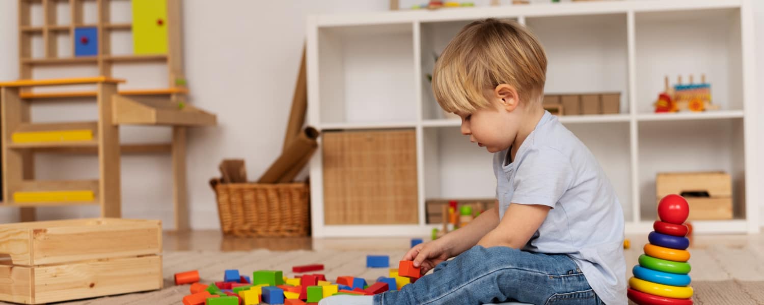 Child participating in sensory play activities during a speech therapy session
