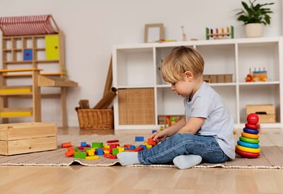 Child participating in sensory play activities during a speech therapy session